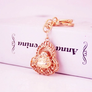 Golden Laughing Buddha keychain with ornate hollow flame halo and rotating ring