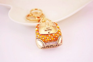 Detail of creative orange enamel backpack keychain with sparkling crystal embellishments