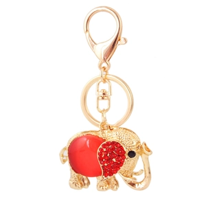 Golden elephant keychain with red rhinestones and crystal details on white background