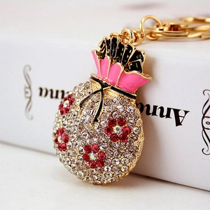 Creative lucky money bag keychain with colorful crystals and pink enamel finish