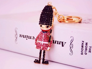 Macro shot of British royal guard keychain with sparkling pink rhinestones and gold clasp