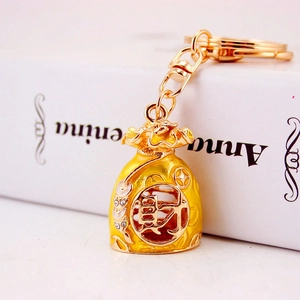 Golden Chinese lucky money bag keychain with hollowed-out character for wealth