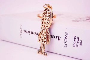 Detail of creative golden soldier keychain with heart and clover hollow patterns on back