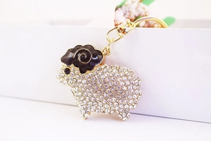 Detail shot of sheep keychain with sparkling white crystals and gold plating