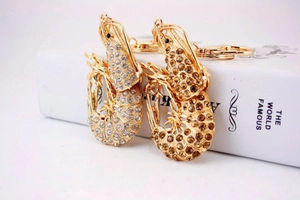 Detail of lobster keychains with sparkling crystals and polished gold metal plating