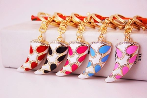 Detail of colorful horn-shaped keychains with crystal rhinestones in gold metal finish