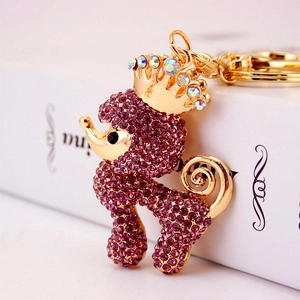 Golden poodle keychain with purple rhinestones and crown accessory for handbags
