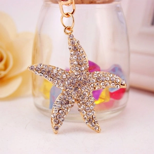 Sparkling starfish keychain with white rhinestones and metal base for women's handbags