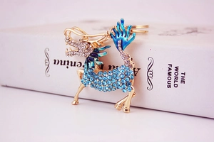 Detail of Kirin keychain featuring blue enamel and sparkling crystal rhinestones
