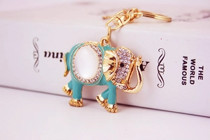 Detail of an elephant keychain with turquoise enamel, opal stone, and sparkling rhinestones