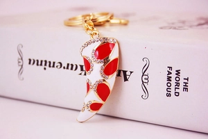 Detailed view of creative horn-shaped enamel keychain with rhinestones on a book