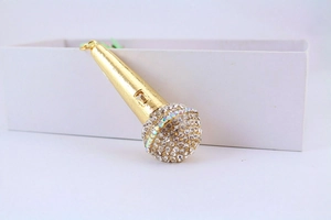 Close-up of golden microphone keychain featuring sparkling crystal rhinestones and metal finish