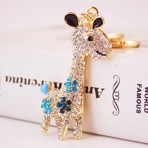 Sparkling crystal giraffe keychain with blue gems on polished gold alloy base