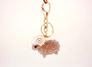 Detailed view of rhinestone sheep keychain with gold lobster clasp and crystal embellishments