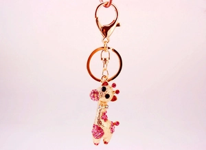 Détail du porte-clés girafe doré avec strass roses et un fermoir mousqueton en métal