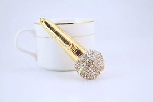 Close-up of golden microphone keychain with sparkling rhinestones and AB crystal detail