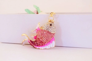 Detail of creative goldfish keychain with pink rhinestones and lobster clasp