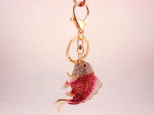 Close-up of sparkling rhinestone koi fish keychain with pink and red crystal gradients