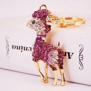 Goldener Ziegen-Schlüsselanhänger mit lila und weißen Strasssteinen und Emaille-Halsband