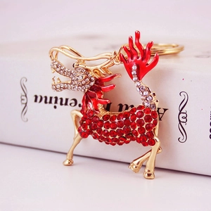 Golden Chinese style Kirin keychain with red rhinestones and enamel on an elegant book