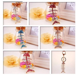 Macro detail of fish bone keychain with colorful crystal rhinestones in multiple finishes
