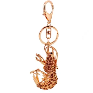 Golden alloy lobster keychain pendant encrusted with brown sparkling rhinestones