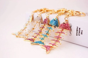 Close-up of sparkling crystal fishbone keychains in five colors with golden hooks