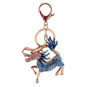 Chinese kylin keychain with blue rhinestones and gold metal lobster clasp on white background