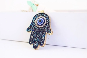 Detail of Hamsa Hand pendant with blue enamel and Evil Eye rhinestone setting