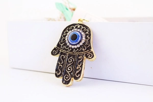 Detail of Hamsa Hand keychain with black enamel, evil eye, and sparkling rhinestones