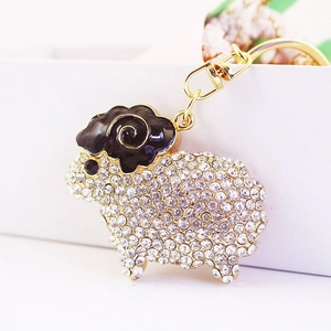 Sparkling crystal sheep keychain with gold-plated horns and lobster clasp on a gift box