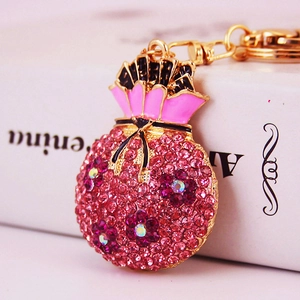Pink rhinestone money bag keychain with gold plating and enamel details for women
