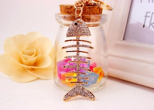 Close-up of golden fishbone keychain with sparkling rhinestones and lobster clasp