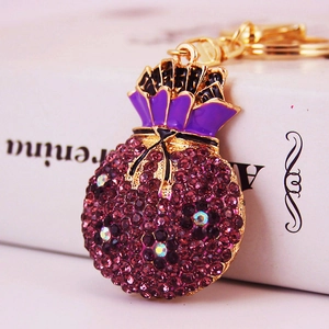 Charming purple money bag keychain with sparkling rhinestones and a black bow detail
