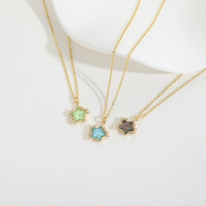 Three gold star necklaces with green, blue, and purple resin stones and rhinestones