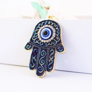 Blue Hamsa Hand keychain with Evil Eye pendant and gold metal swirling patterns