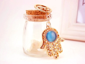 Detailansicht goldener Hamsa-Hand Schlüsselanhänger mit blauem Opal und Kristallen