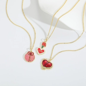 Gold-plated heart pendant necklace set with enamel love patterns and rose details