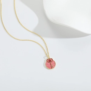 Romantic 14k gold plated necklace with a pink glitter heart pendant on white background