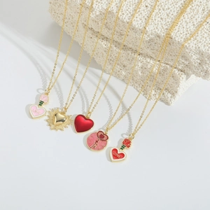 Five assorted heart-shaped pendant necklaces with pink and red enamel in 14k gold finish