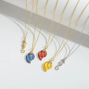 Colorful seahorse and shell pendant necklaces with zircon inlay on white display