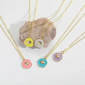 Retro seashell pendant necklaces in yellow, white, pink, blue, and purple set on gold chains