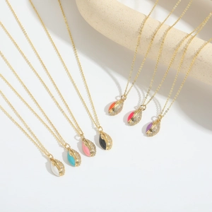 Close-up of colorful enamel and sparkling zircon football style pendants on gold chains