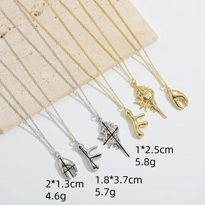 Marine style necklaces with gold and silver crab claw, coral, and conch pendants
