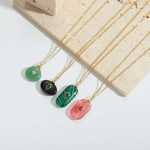 Detailed macro shot of four geometric natural stone necklaces with delicate gold chains
