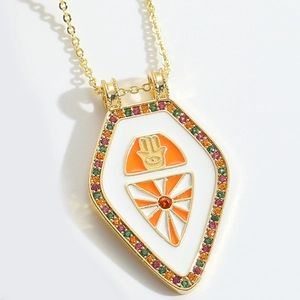 Gold Hamsa Hand shield pendant necklace with orange enamel and colorful zircons