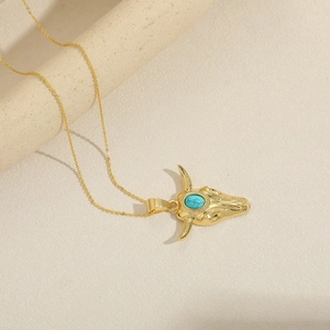 Bohemian gold bull head pendant necklace featuring a central turquoise stone for women