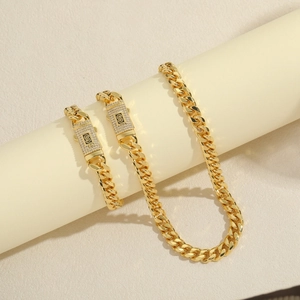 Ensemble collier et bracelet maille gourmette plaqué or 14 carats avec fermoir monogramme S