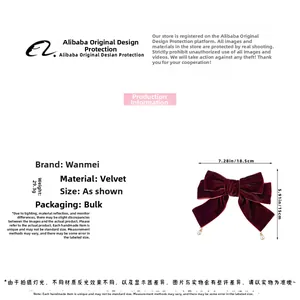 Detail view of a burgundy velvet bow hair clip with pearls and specific size dimensions