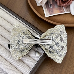 Elegant palace style lace bow hair clip with rhinestones and metal pendant detail
